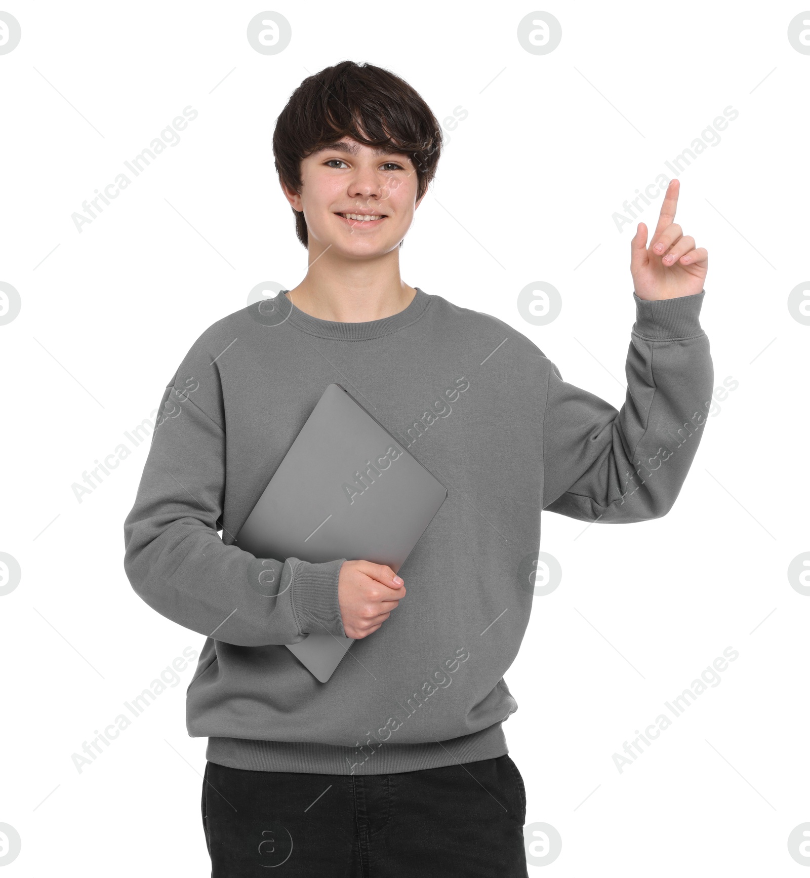Teenage boy with laptop on white background Photo of Teenage boy with laptop on white background