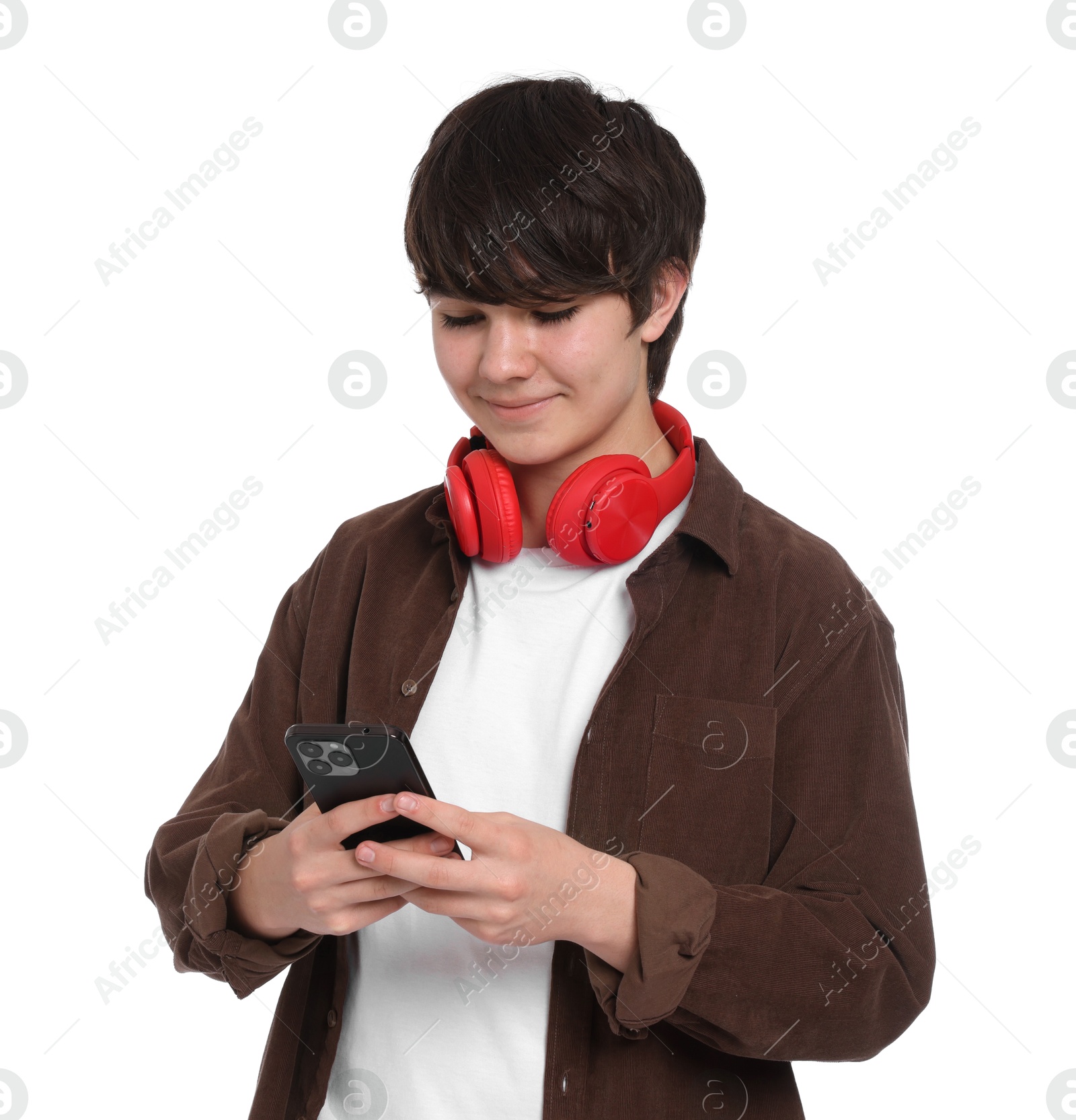 Teenage boy with headphones and smartphone on white background Photo of Teenage boy with headphones and smartphone on white background