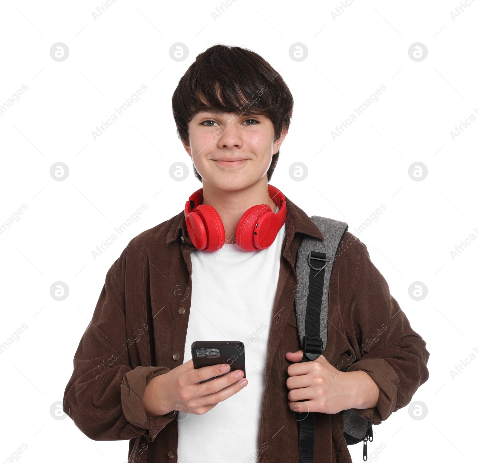 Teenage boy with backpack, headphones and smartphone on white background Photo of Teenage boy with backpack, headphones and smartphone on white background