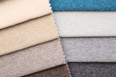 Photo of Samples of different fabrics as background, top view
