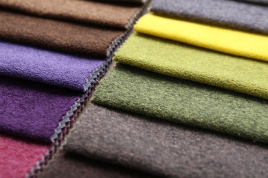 Photo of Samples of different fabrics as background, closeup
