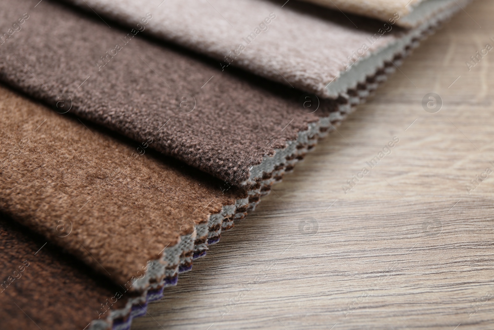 Samples of different fabrics on wooden table, closeup Photo of Samples of different fabrics on wooden table, closeup