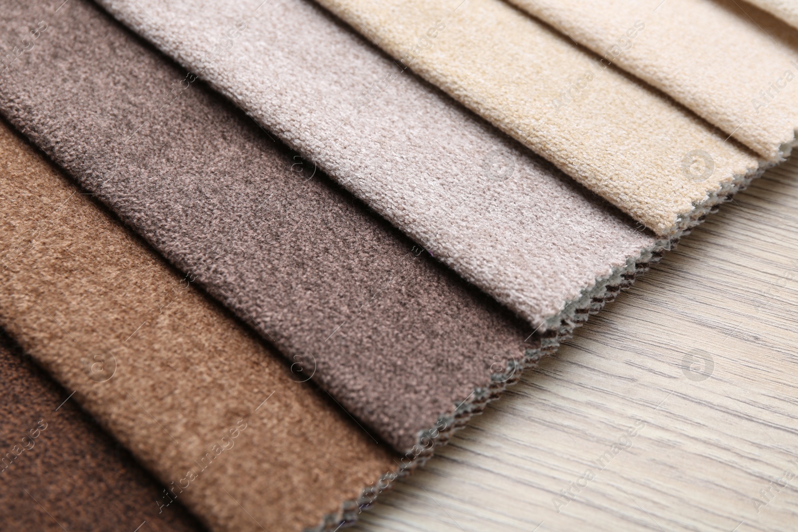 Samples of different fabrics on wooden table, closeup Photo of Samples of different fabrics on wooden table, closeup