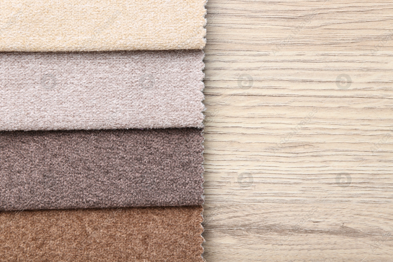 Samples of different fabrics on wooden table, top view. Space for text Photo of Samples of different fabrics on wooden table, top view. Space for text