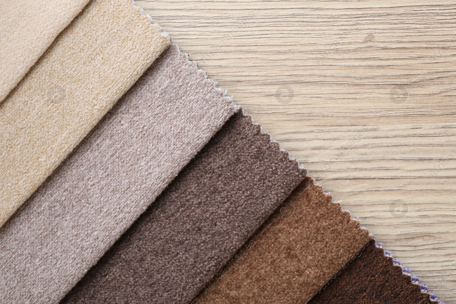 Samples of different fabrics on wooden table, top view. Space for text Photo of Samples of different fabrics on wooden table, top view. Space for text