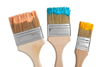 Photo of Brushes with different paints isolated on white