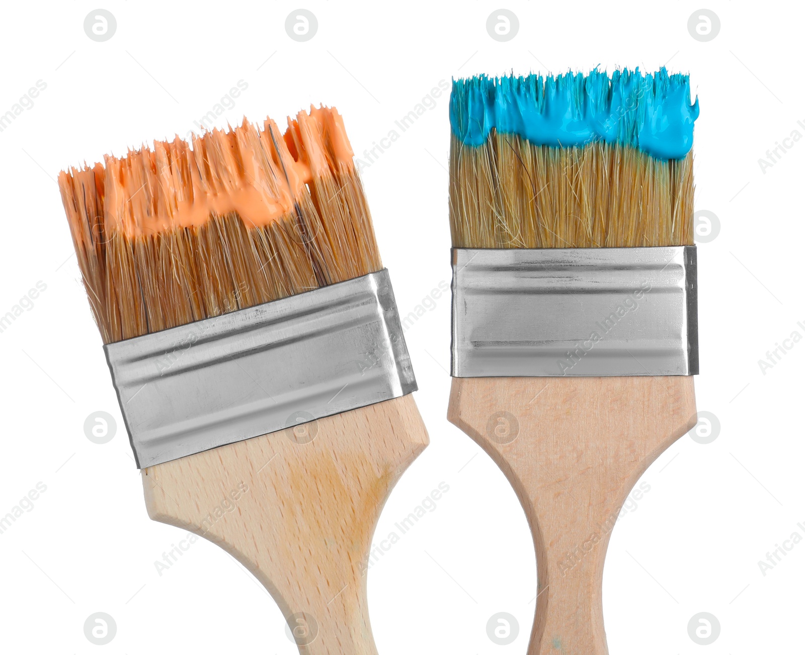 Photo of Brushes with orange and light blue paints isolated on white