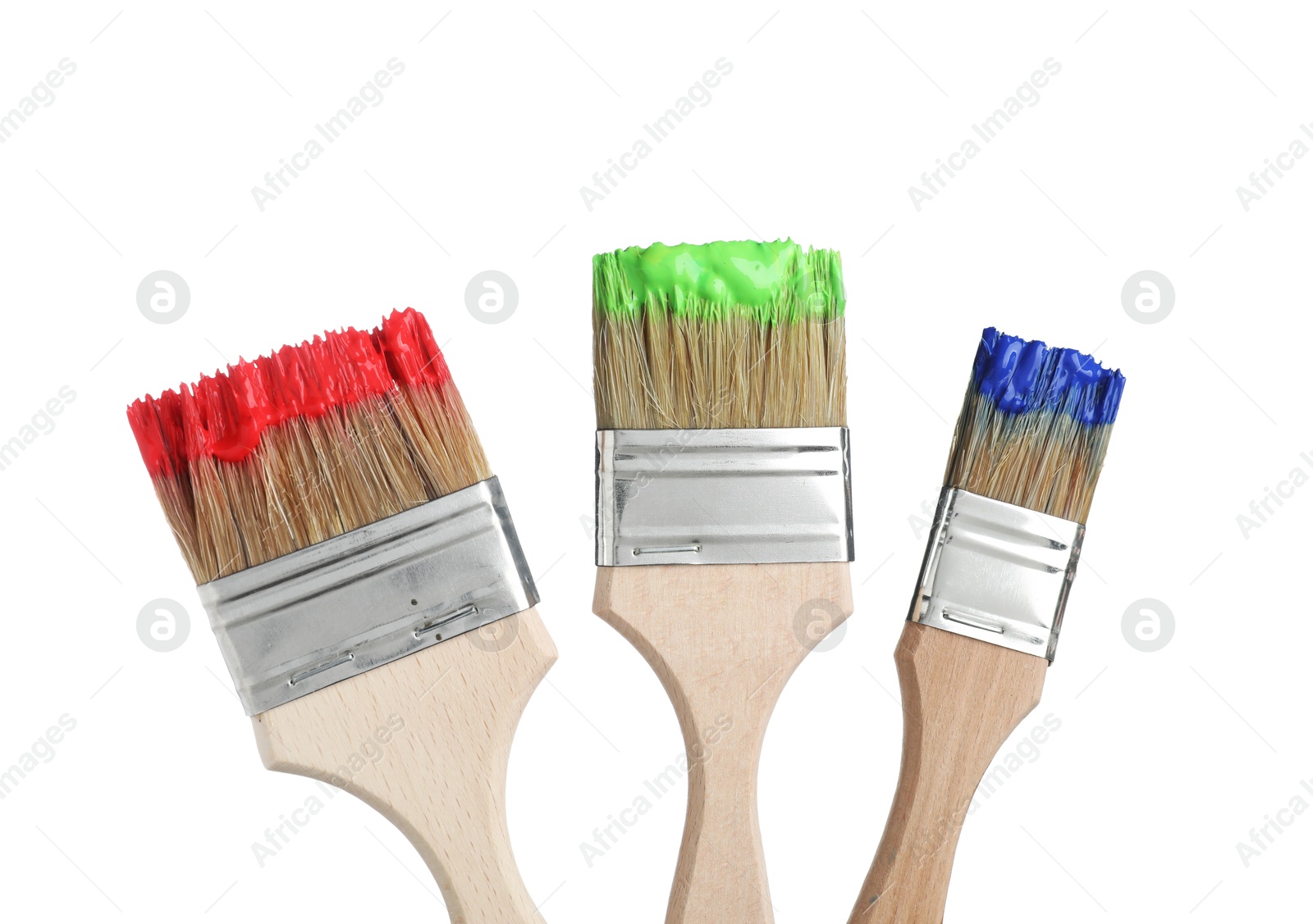 Brushes with different paints isolated on white Photo of Brushes with different paints isolated on white