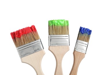 Photo of Brushes with different paints isolated on white