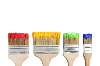 Photo of Brushes with different paints isolated on white
