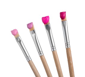 Photo of Brushes with different paints isolated on white