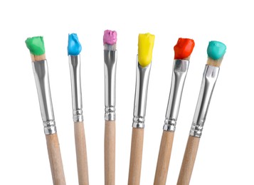 Photo of Brushes with different paints isolated on white