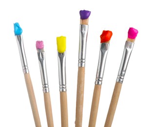 Photo of Brushes with different paints isolated on white