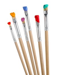 Photo of Brushes with different paints isolated on white