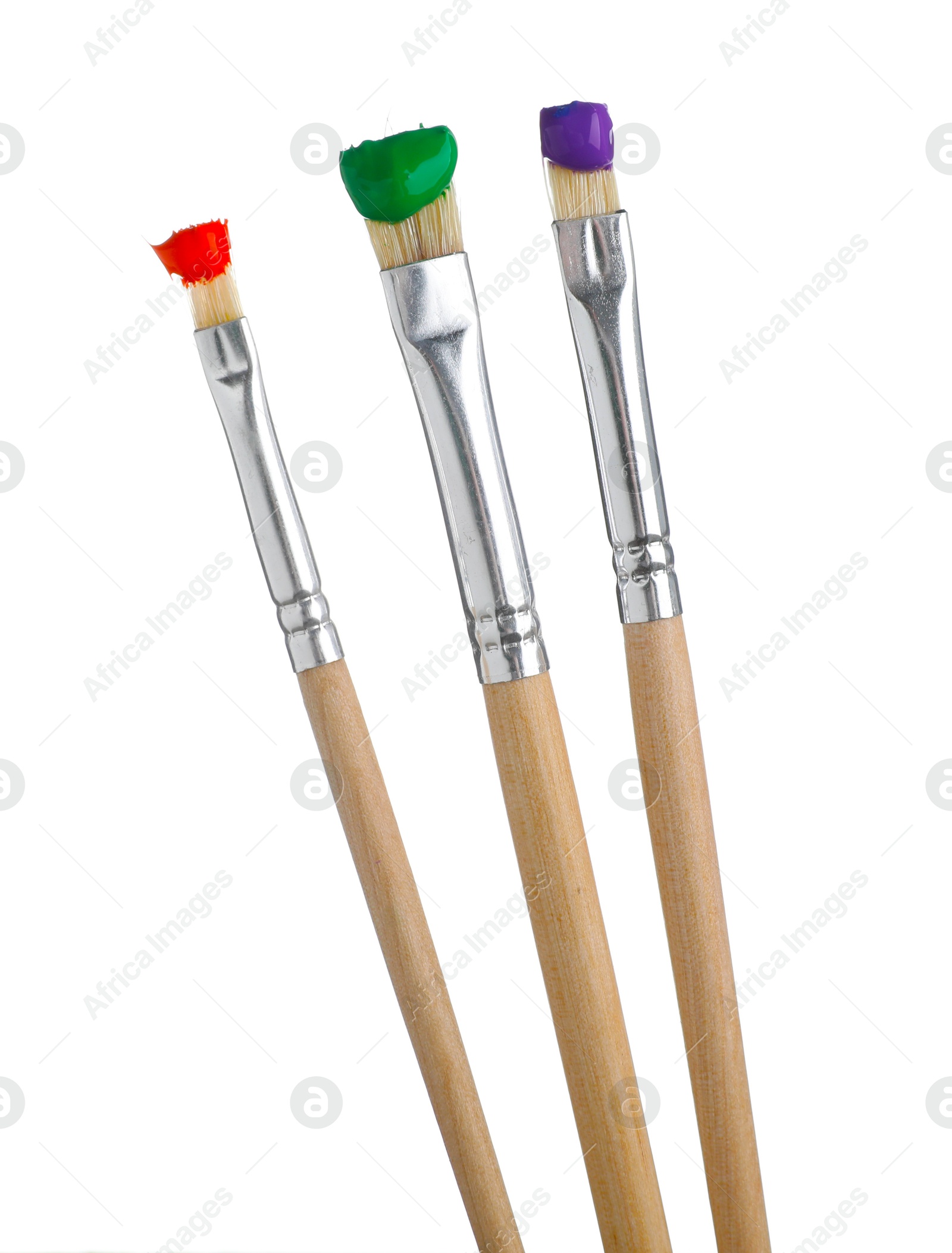 Brushes with different paints isolated on white Photo of Brushes with different paints isolated on white