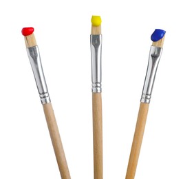 Photo of Brushes with different paints isolated on white