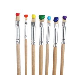 Photo of Brushes with different paints isolated on white