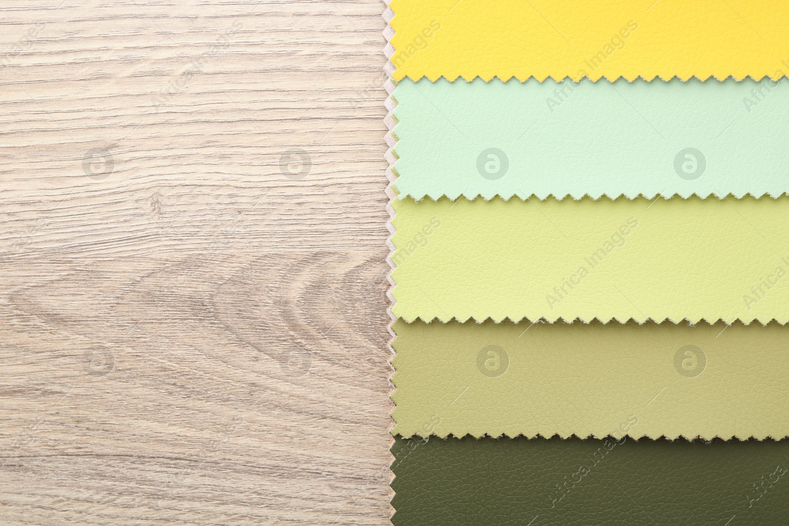 Samples of different fabrics on wooden table, top view. Space for text Photo of Samples of different fabrics on wooden table, top view. Space for text