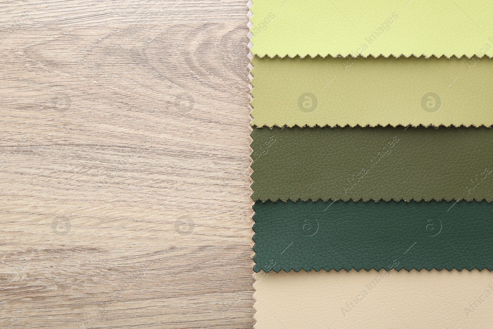 Samples of different fabrics on wooden table, top view. Space for text Photo of Samples of different fabrics on wooden table, top view. Space for text