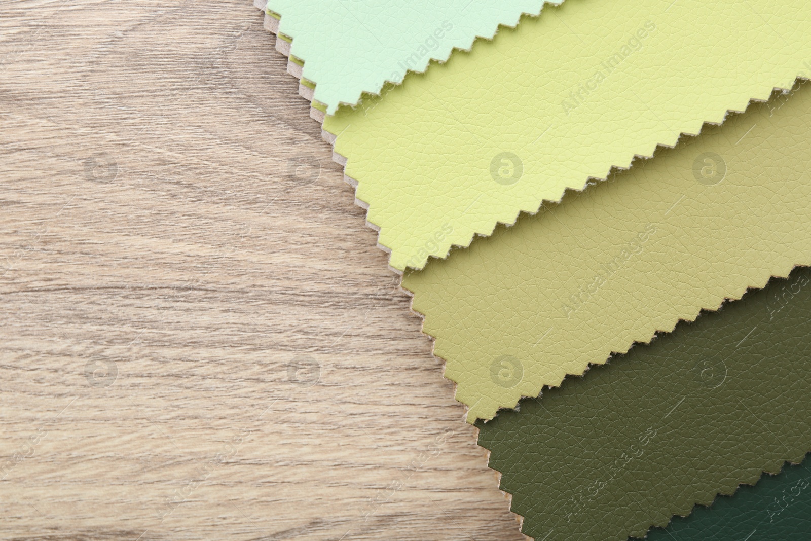 Samples of different fabrics on wooden table, top view. Space for text Photo of Samples of different fabrics on wooden table, top view. Space for text