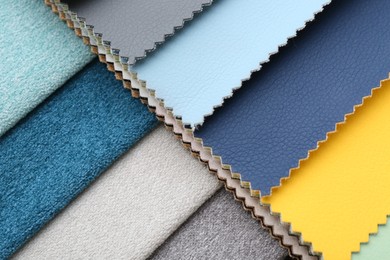 Photo of Samples of different fabrics as background, closeup