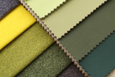 Photo of Samples of different fabrics as background, top view
