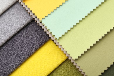 Photo of Samples of different fabrics as background, top view