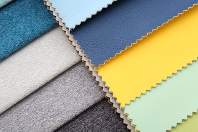 Photo of Samples of different fabrics as background, top view