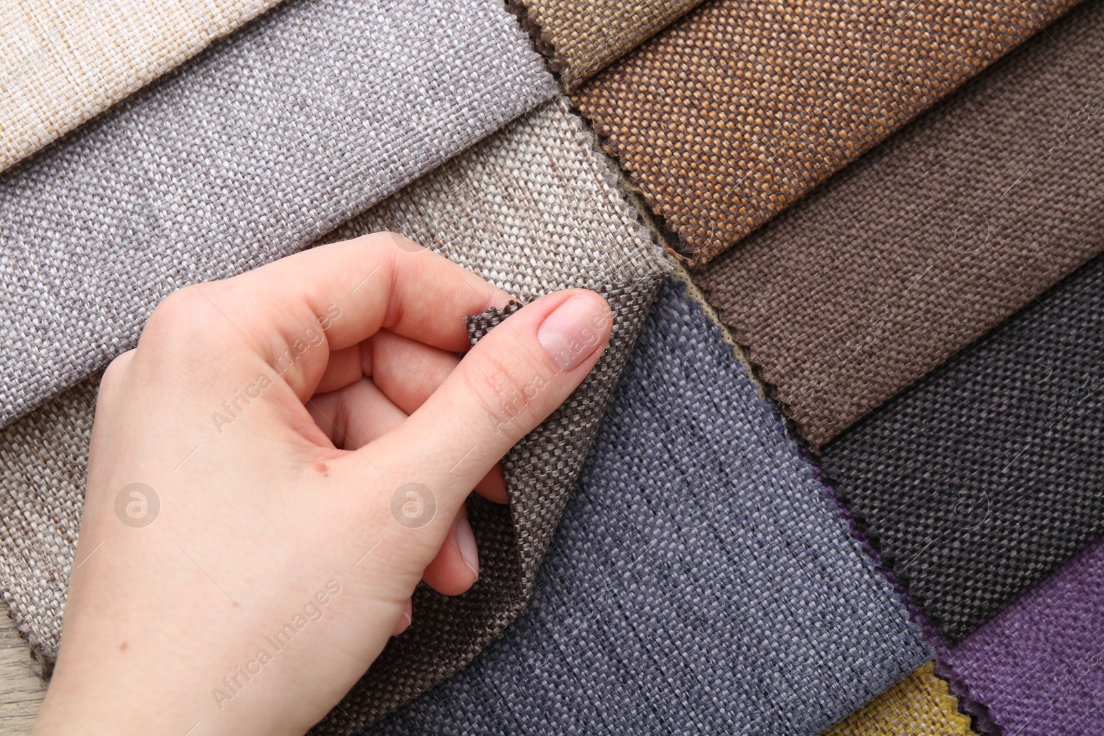 Woman with samples of different fabrics, top view Photo of Woman with samples of different fabrics, top view