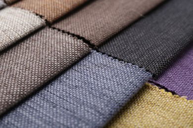 Photo of Samples of different fabrics as background, closeup