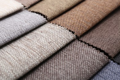Photo of Samples of different fabrics as background, closeup