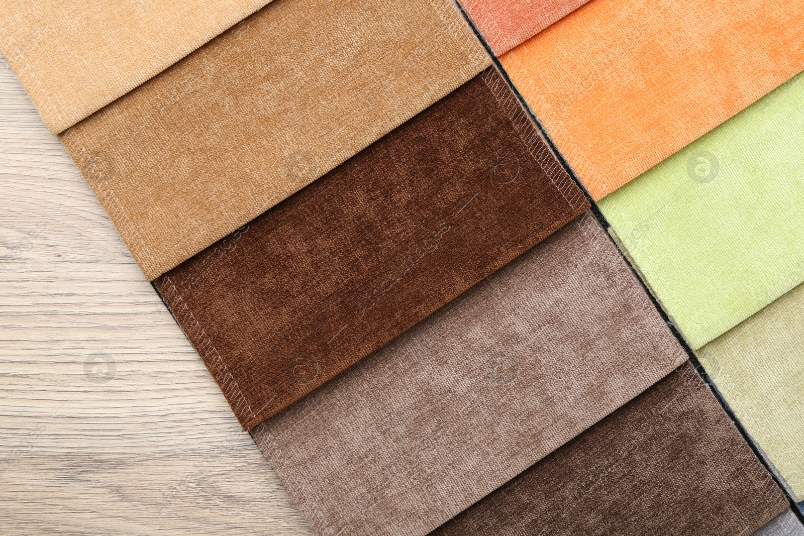 Samples of different fabrics on wooden table, top view Photo of Samples of different fabrics on wooden table, top view
