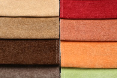 Photo of Samples of different fabrics as background, top view