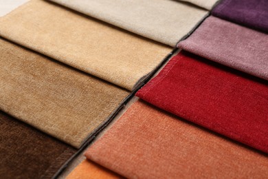 Photo of Samples of different fabrics as background, closeup