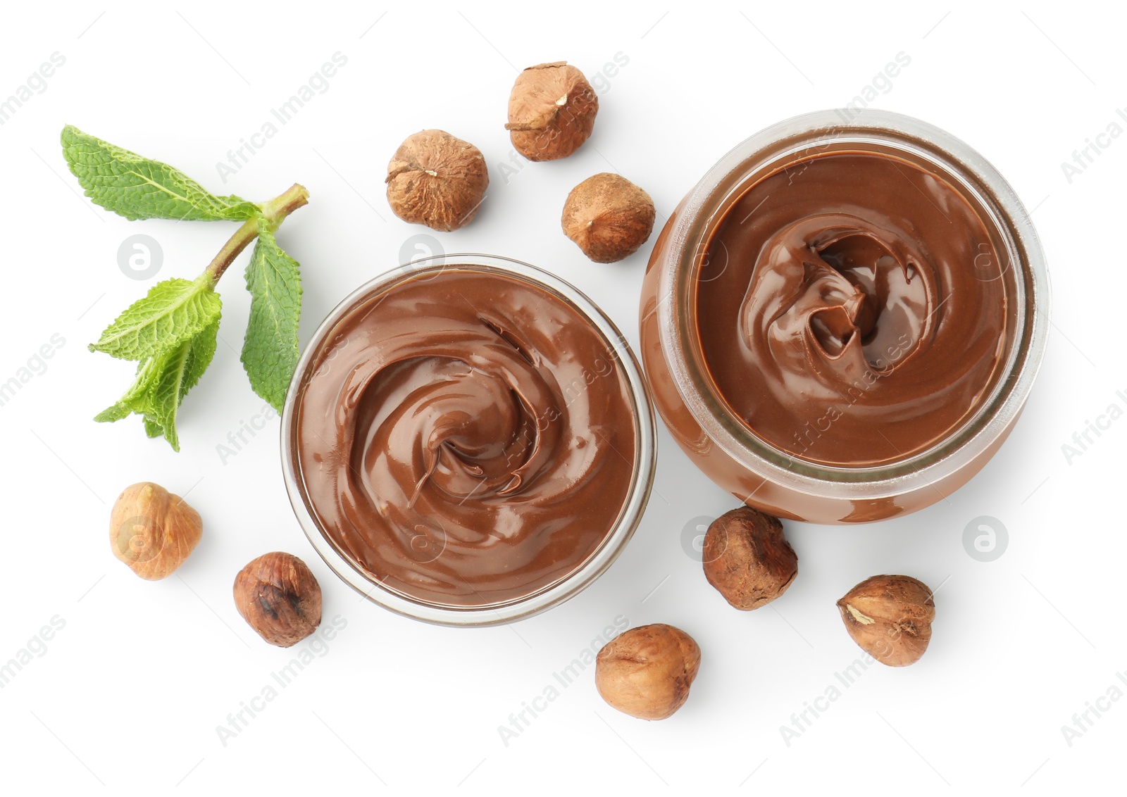 Tasty chocolate spread, hazelnuts and mint isolated on white, top view Photo of Tasty chocolate spread, hazelnuts and mint isolated on white, top view