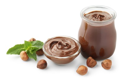 Photo of Tasty chocolate spread, hazelnuts and mint isolated on white