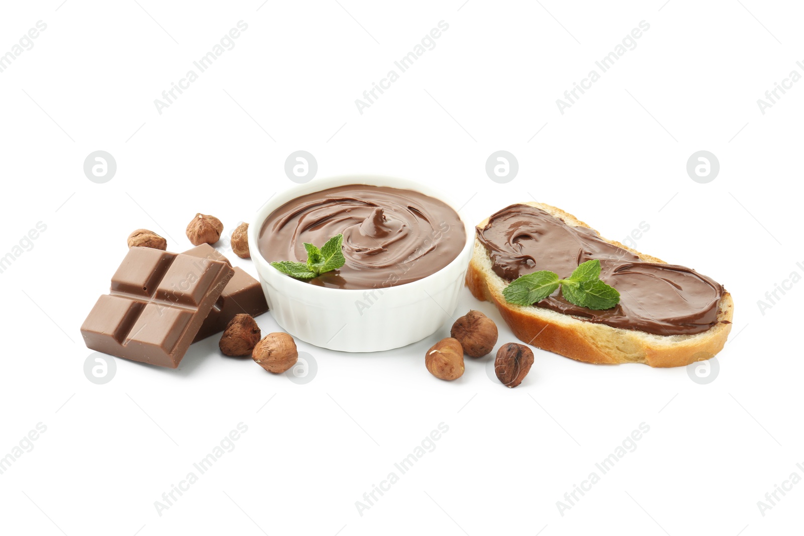 Tasty chocolate spread with mint in bowl, toast and hazelnuts isolated on white Photo of Tasty chocolate spread with mint in bowl, toast and hazelnuts isolated on white