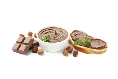 Photo of Tasty chocolate spread with mint in bowl, toast and hazelnuts isolated on white