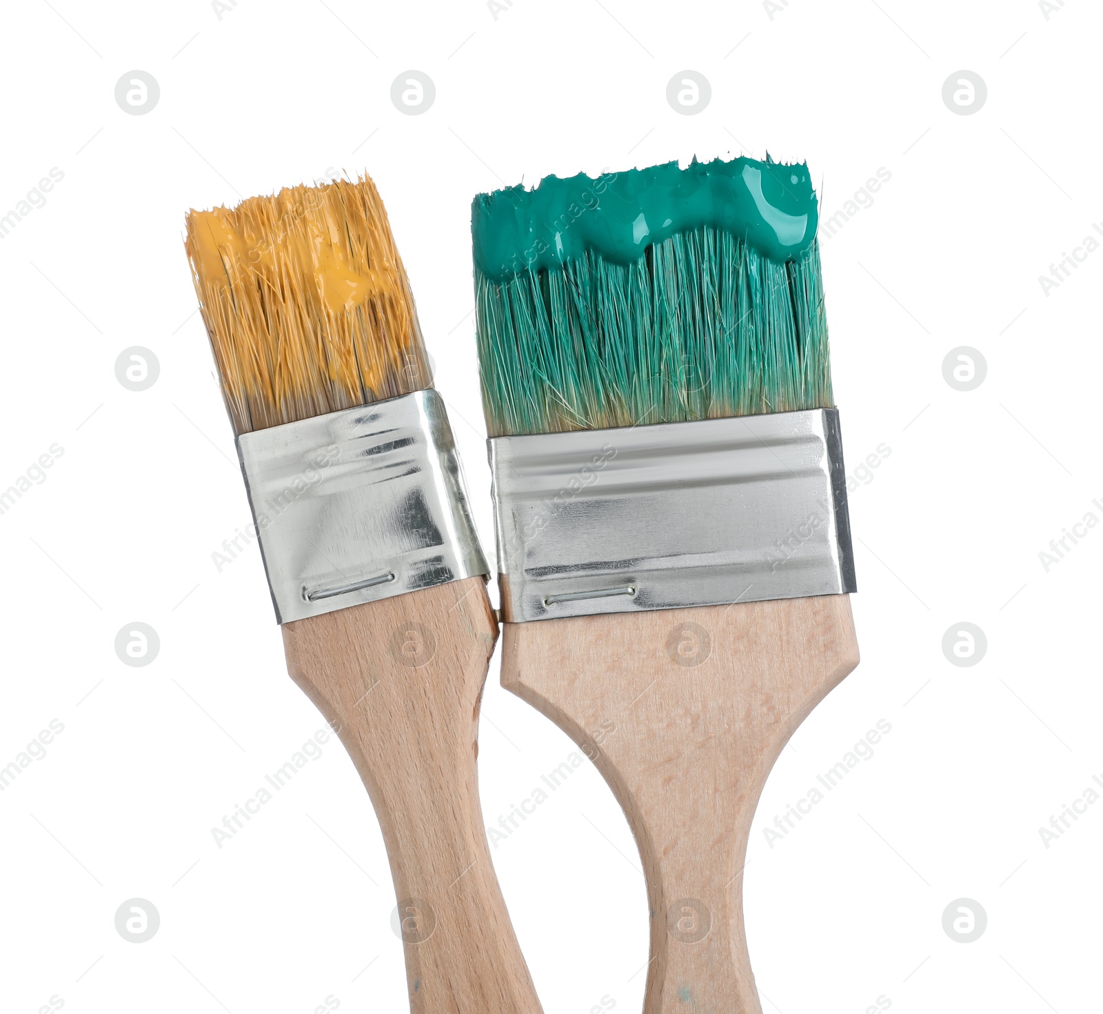 Brushes with green and orange paints isolated on white Photo of Brushes with green and orange paints isolated on white