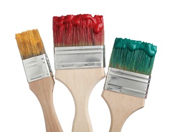 Photo of Brushes with different paints isolated on white