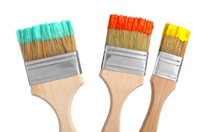 Photo of Brushes with different paints isolated on white