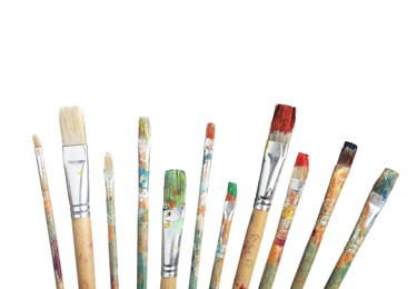 Photo of Brushes with different paints isolated on white