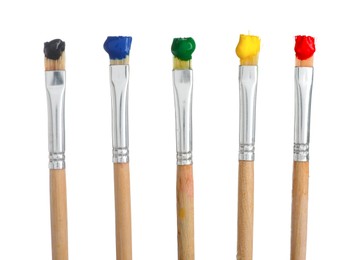 Photo of Brushes with different paints isolated on white