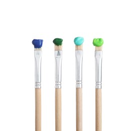 Photo of Brushes with different paints isolated on white