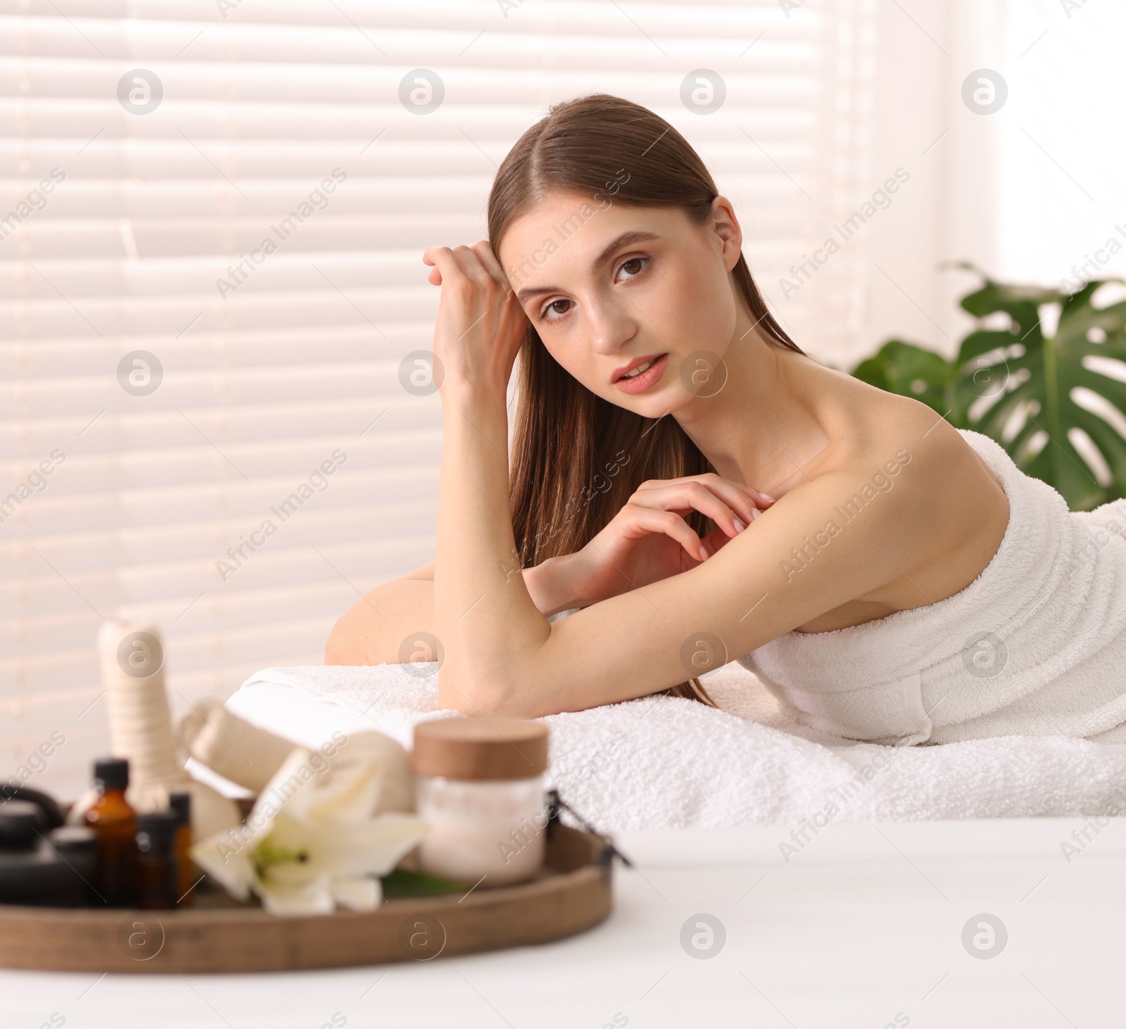 Beautiful woman relaxing on massage couch in spa salon, selective focus Photo of Beautiful woman relaxing on massage couch in spa salon, selective focus