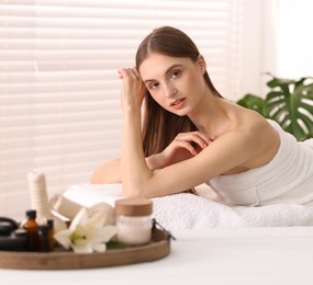Photo of Beautiful woman relaxing on massage couch in spa salon, selective focus