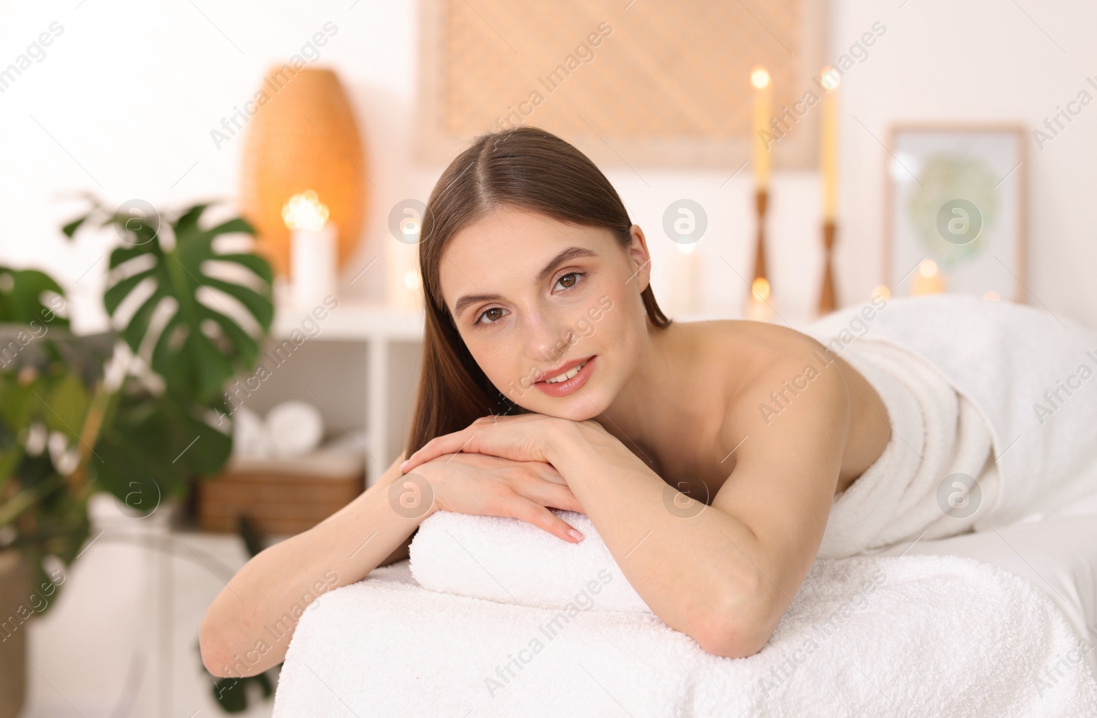 Beautiful woman relaxing on massage couch in spa salon Photo of Beautiful woman relaxing on massage couch in spa salon