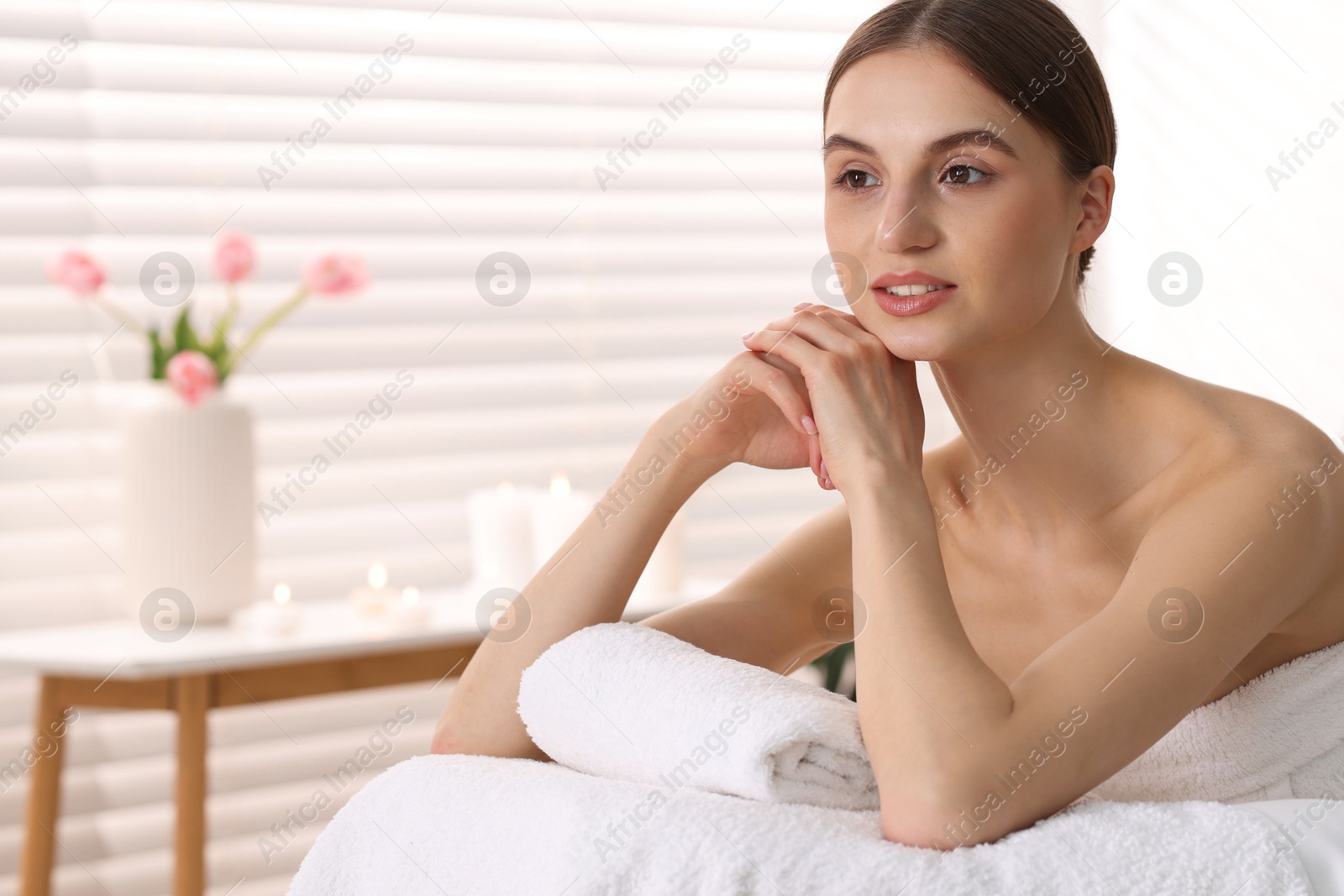 Beautiful woman relaxing on massage couch in spa salon Photo of Beautiful woman relaxing on massage couch in spa salon