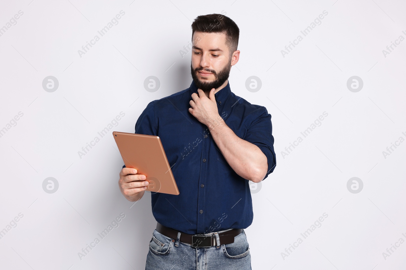 Handsome man using tablet on white background Photo of Handsome man using tablet on white background