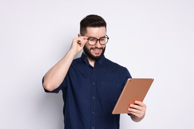 Photo of Handsome man using tablet on white background